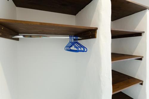 a room with wooden shelves on a wall at Apágkio Filoxenia in Archangelos