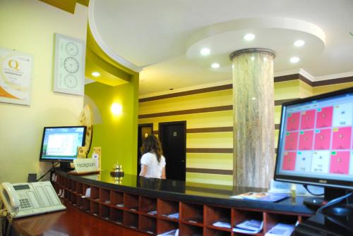 a woman standing at the counter of a restaurant at Hotel Iacone in Chieti