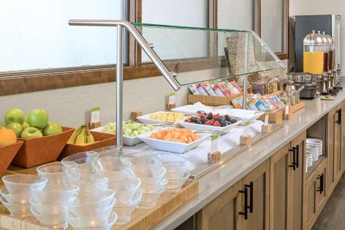 a buffet with bowls of food on a counter at DoubleTree by Hilton Boston-Rockland in Rockland