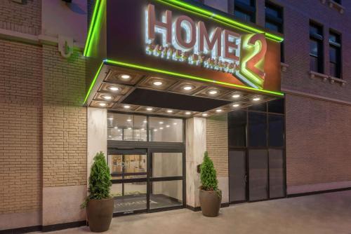 a store front with a sign that says home at Home2 Suites by Hilton Atlanta Downtown in Atlanta