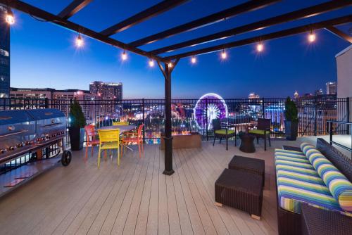 a rooftop deck with tables and chairs at night at Home2 Suites by Hilton Atlanta Downtown in Atlanta
