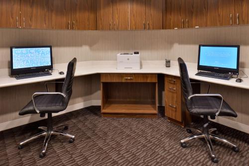 an office with two desks with two computers on them at Hampton Inn & Suites Ann Arbor West in Ann Arbor