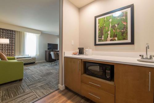 a hotel room with a kitchen with a microwave at Hampton Inn Waynesboro in Waynesboro