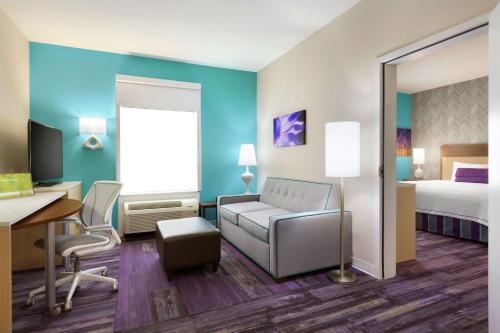 a hotel room with a bed and a desk at Home2 Suites by Hilton West Monroe in West Monroe
