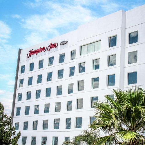 a large white building with a sign on it at Hampton Inn by Hilton Durango in Durango