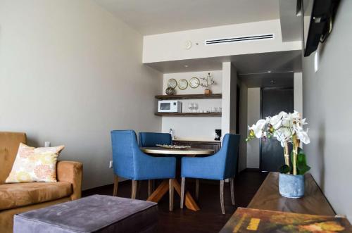 a living room with a table and blue chairs at Hampton Inn by Hilton Durango in Durango