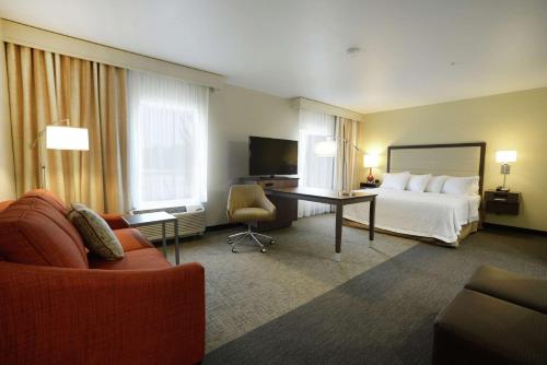 a hotel room with a bed and a desk at Hampton Inn & Suites Ponca City in Ponca City
