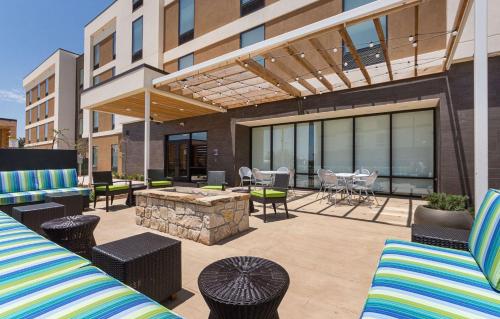 a patio with furniture and a fire pit on a building at Home2 Suites By Hilton Oklahoma City Yukon in Yukon
