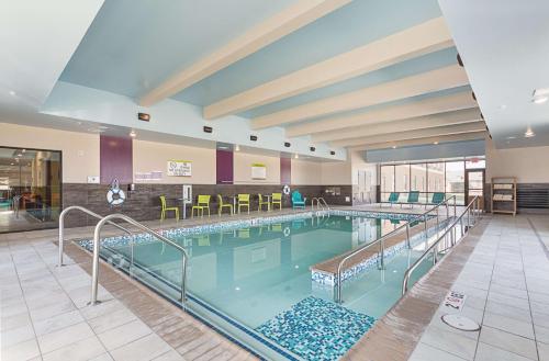a large swimming pool in a large building at Home2 Suites By Hilton Oklahoma City Yukon in Yukon