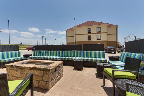 a patio with chairs and a fire pit and a building at Home2 Suites By Hilton Oklahoma City Yukon in Yukon