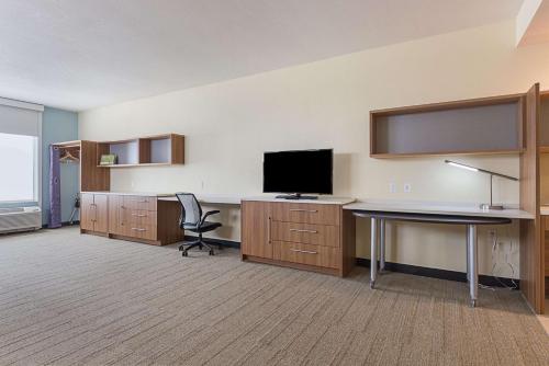 an office with a desk and a television in a room at Home2 Suites By Hilton Oklahoma City Yukon in Yukon