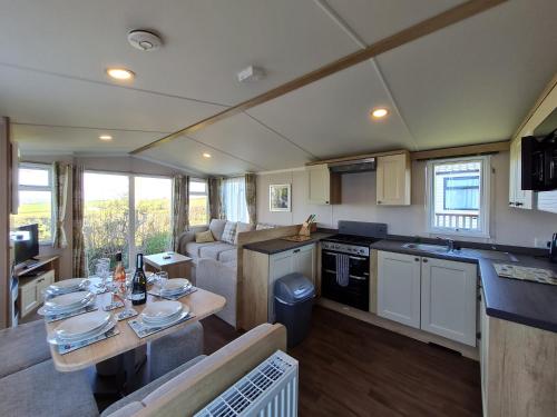 a kitchen and living room of a caravan at Polborder Holidays Looe Country Park in Looe