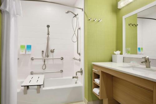 a bathroom with a tub shower and a sink at Home2 Suites by Hilton Shenandoah The Woodlands in The Woodlands