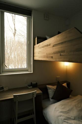 a bedroom with a bed and a window and a desk at HOTEL BOTH - Vacation STAY 90935v in Shari
