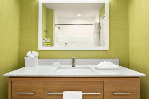 a bathroom with a sink and a mirror at Home2 Suites by Hilton Shenandoah The Woodlands in The Woodlands