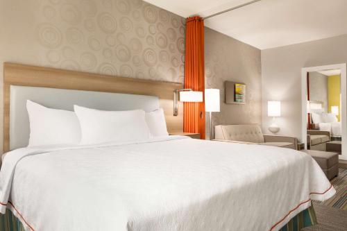 a large white bed in a hotel room at Home2 Suites by Hilton Shenandoah The Woodlands in The Woodlands