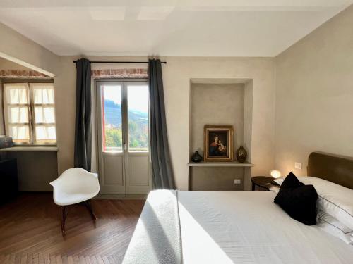 a bedroom with a white bed and a window at MiaClara Relais in Alba