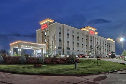 a hotel building with a lawn in front of it at Hampton Inn & Suites Guthrie, OK in Guthrie
