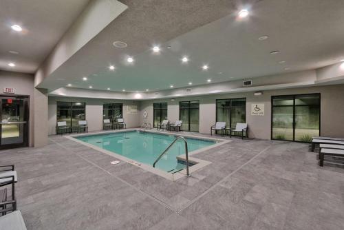 a swimming pool in a large building with a pool at Hampton Inn & Suites Guthrie, OK in Guthrie