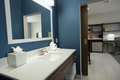 a bathroom with a sink and a mirror at Home2 Suites by Hilton Tulsa Hills in Tulsa