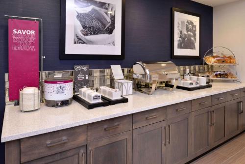 a salon with a counter with some food on it at Hampton Inn & Suites Albany-East Greenbush, NY in East Greenbush
