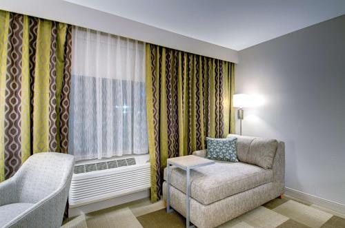 a living room with a couch and a window at Hampton Inn Boston - Westborough in Westborough