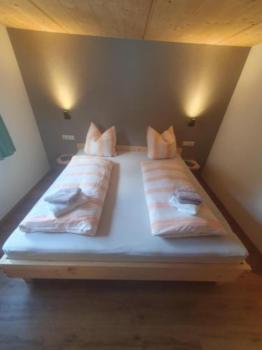 a bed with two pillows on it in a room at FeWo Fritz in Bad Hindelang