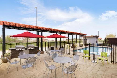a patio with tables and chairs and a pool at Home2 Suites By Hilton Baton Rouge in Baton Rouge