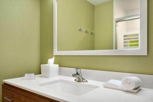 a bathroom with a sink and a mirror at Home2 Suites By Hilton Baton Rouge in Baton Rouge