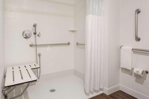 a bathroom with a shower with a shower curtain at Hampton Inn & Suites Newport/Cincinnati, KY in Newport