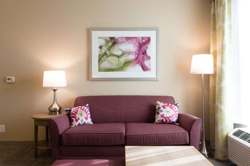 a living room with a purple couch and two lamps at Homewood Suites by Hilton Concord in Concord