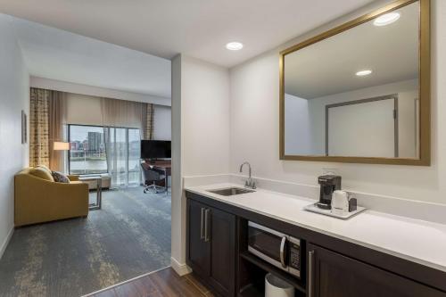 a bathroom with a sink and a mirror at Hampton Inn & Suites Newport/Cincinnati, KY in Newport