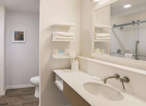 a white bathroom with a sink and a mirror at Hampton Inn & Suites Colleyville DFW Airport West in Colleyville