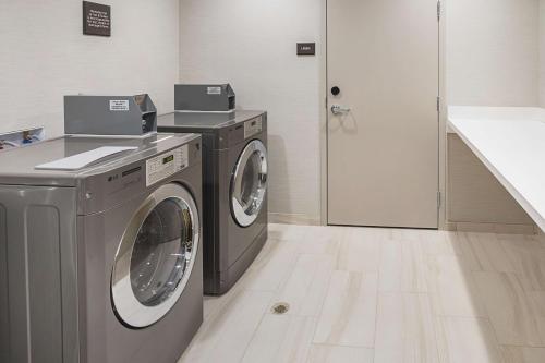 a laundry room with a washer and dryer at Hampton Inn & Suites Colleyville DFW Airport West in Colleyville
