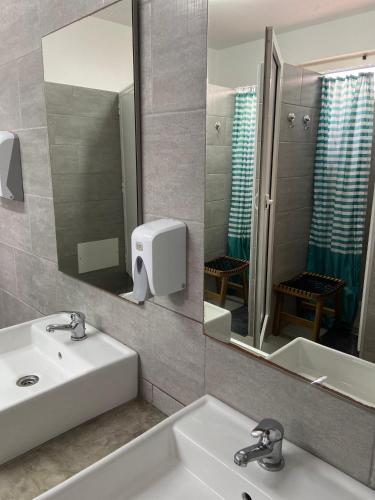 a bathroom with a sink and a mirror at Guesthouse Releash Aljezur in Aljezur