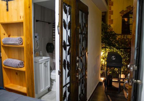 an open door to a bathroom with a toilet at Casa céntrica con garaje in Taxco de Alarcón