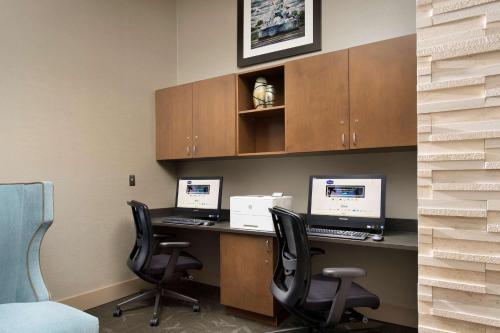 an office with two computers on a desk with chairs at Hampton Inn Wilmington Downtown in Wilmington