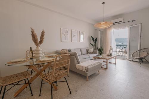 a living room with a table and a couch at La Mer in Agios Rokkos