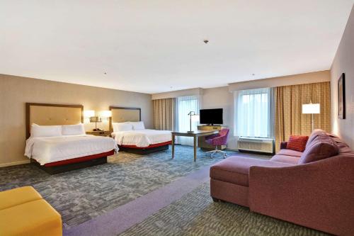Habitación de hotel con 2 camas y sofá en Hampton Inn Suites Ashland, Ohio, en Ashland