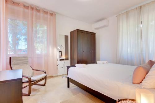 ein Schlafzimmer mit einem Bett und einem Stuhl und einem Fenster in der Unterkunft NEW 2024 Apartment Marchesi Vodnjan in Vodnjan