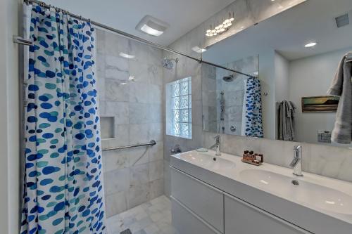 a bathroom with a sink and a shower at The Home Collection CLT: 510 Queens in Charlotte