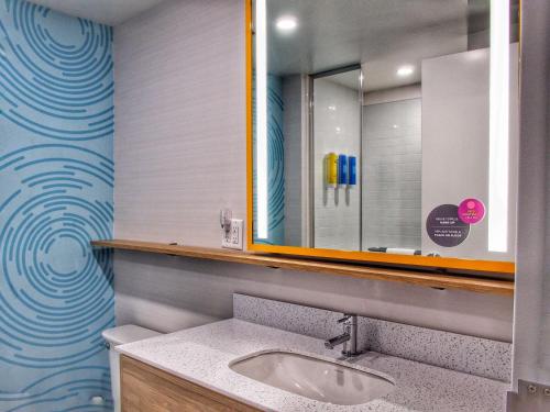 bagno con lavandino e specchio di Tru By Hilton Oklahoma City Airport, Ok a Oklahoma City