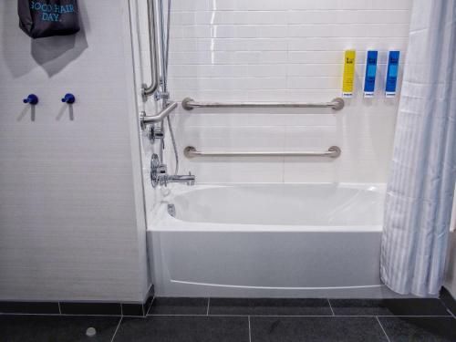 a bathroom with a shower and a white tub at Tru By Hilton Oklahoma City Airport, Ok in Oklahoma City