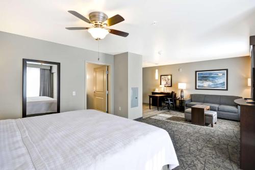 a bedroom with a bed and a couch at Homewood Suites By Hilton Phoenix Tempe Asu Area in Tempe