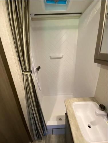 a bathroom with a shower and a sink at Eden Farm RV Minutes from Salisbury in Eden