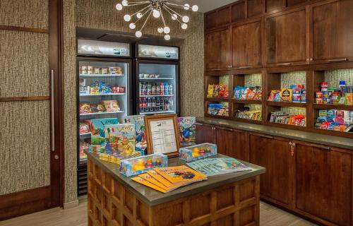 a store with a counter with food on it at Homewood Suites by Hilton St. Louis Westport in Maryland Heights