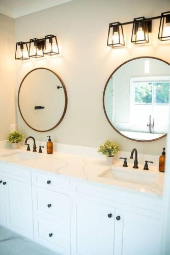 a bathroom with two sinks and a mirror at BRAND NEW: Urban Oasis 5 min from Mercedes Benz in Atlanta