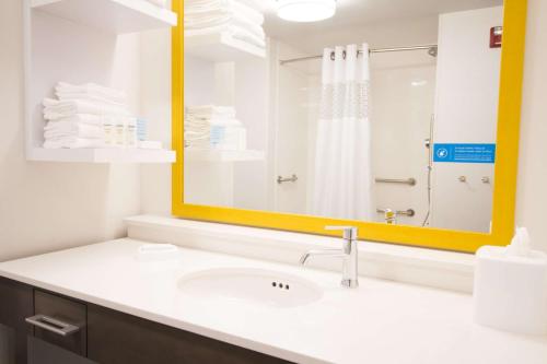 a bathroom with a sink and a large mirror at Hampton Inn Decatur, Mt. Zion, IL in Decatur