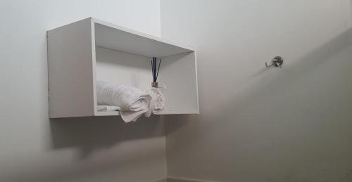 a white cabinet with a towel hanging from it at Hospedaria Salém in Soure