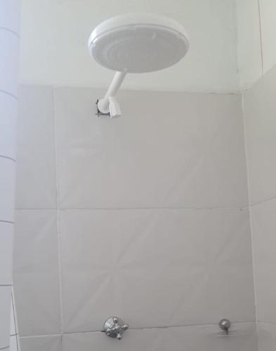 a bathroom with a white ceiling with a sink at Hospedaria Salém in Soure